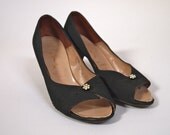 Vintage 1950s peep toe kitten heels in black matte satin twill with rhinestone flower detail