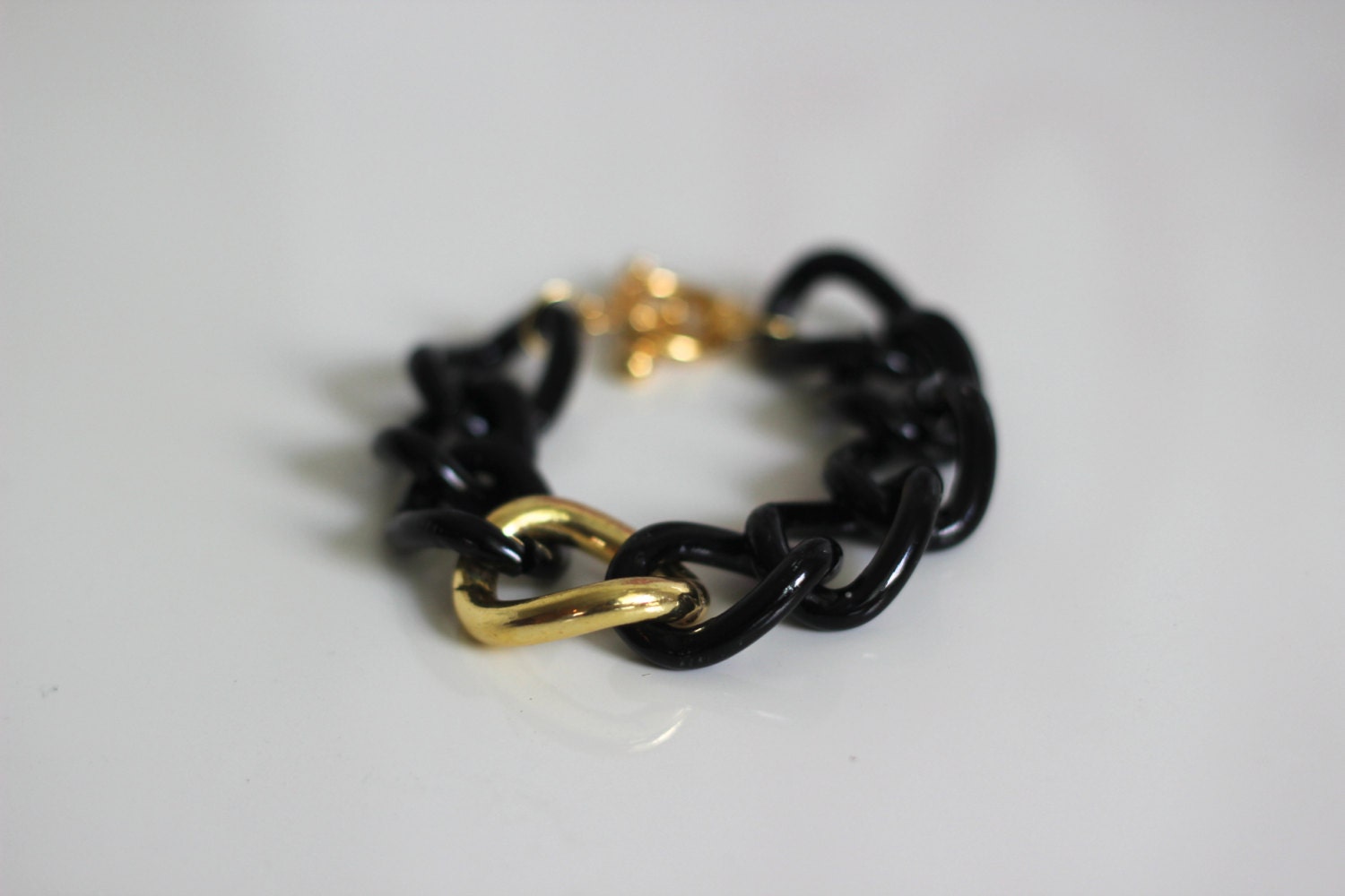 The Golden Cool Bracelet. Black chain bracelet with large gold link and toggle clasp closure
