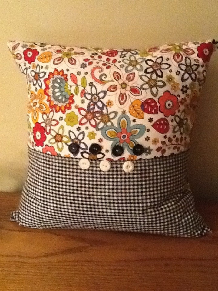Multicolor, paisley and plaid pillow.