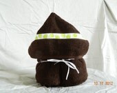 Chocolate brown hooded bath towel with decorative froggy ribbon trim.  Other color towels available are white, tan, hot pink, or lime green.