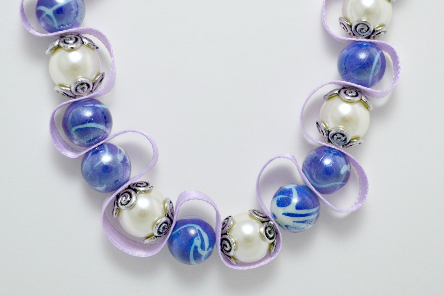 Blue and white bead necklace with light purple ribbon. Beaded ribbon. Silver encased white pearls. Ships free to U.S.