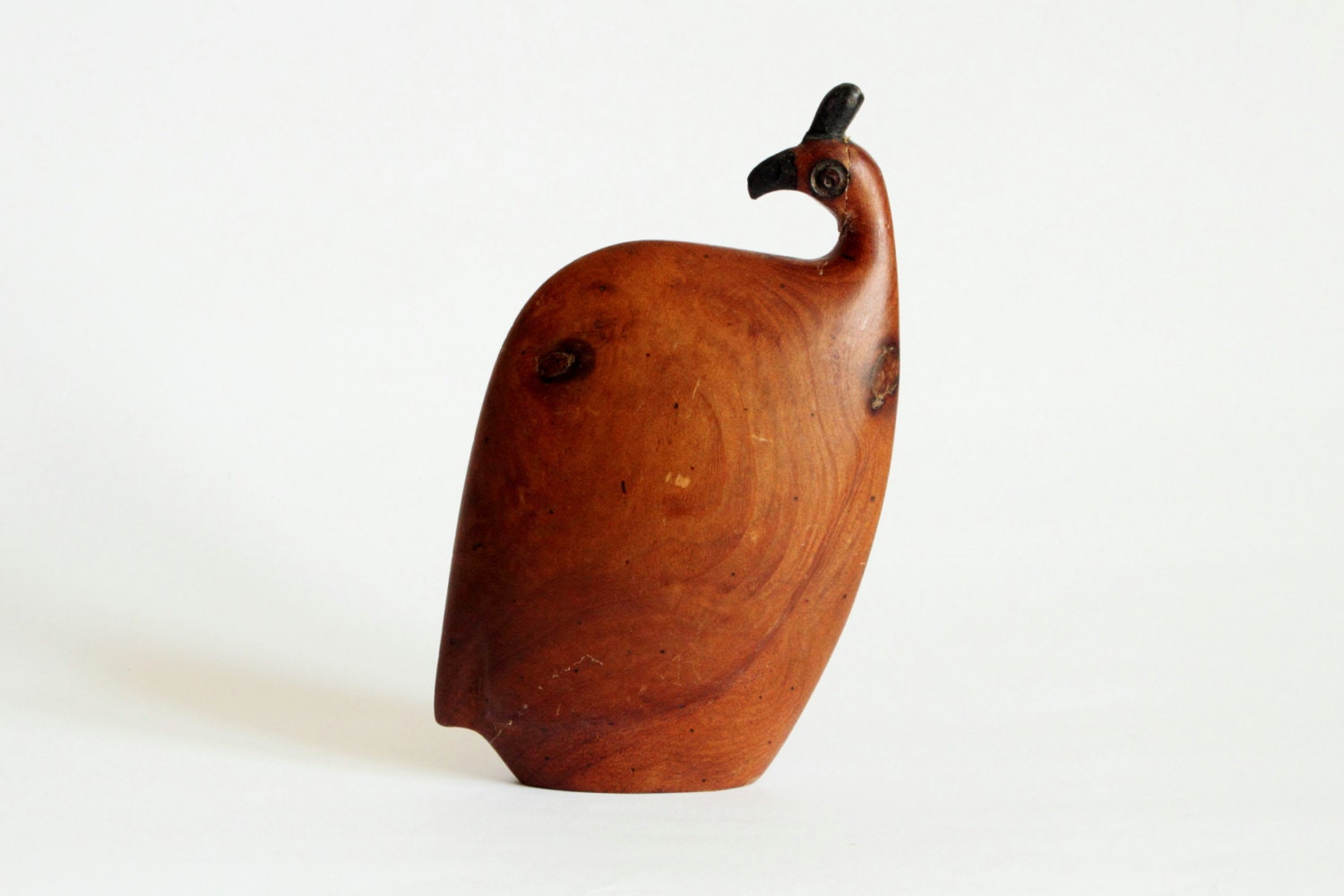 Peacock, teak, signed.