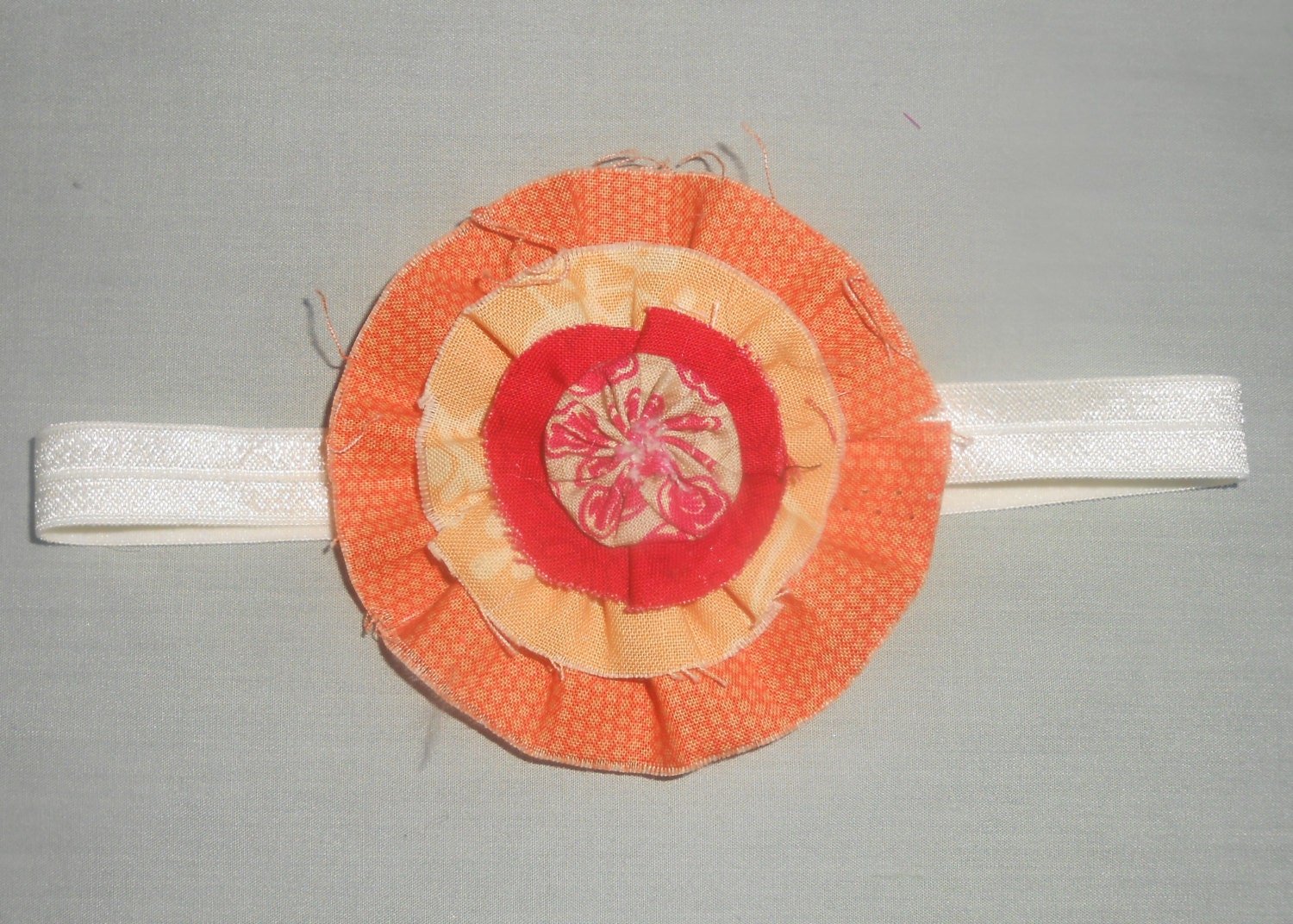 Orange and red fabric yoyo headband for toddler or child