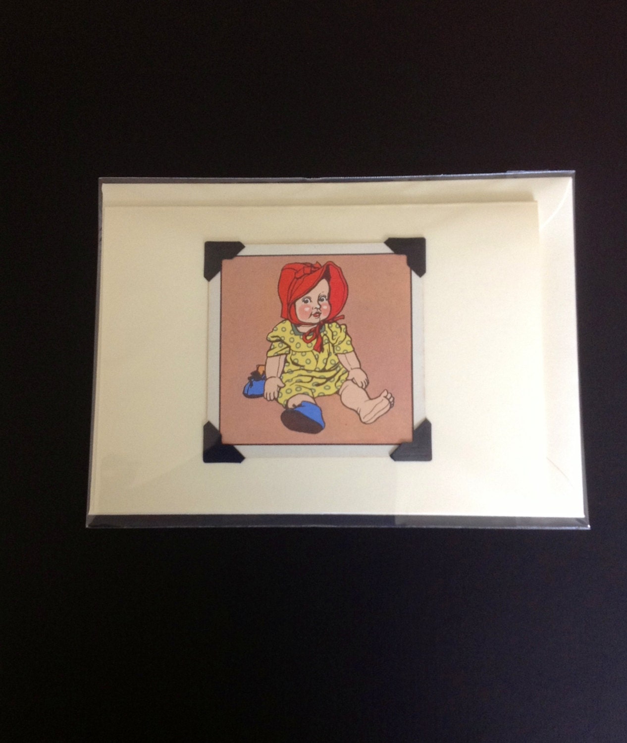 Handmade card featuring a 1950's snap card, with an illustration of a vintage toy doll, drawn by Willy Mayrl