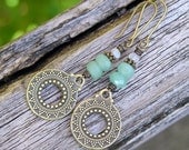 bohemian gemstone dangle earrings with green aventurine, rainbow moonstone, and antiqued brass. hippie style.