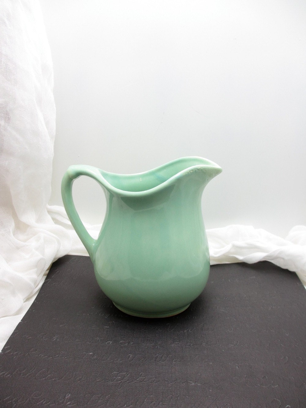 Vintage ceramic pitcher in mint green