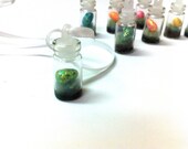 Fairy Egg Specimen in a tiny glass vial pendant, sparkling on a bed of cashmere wool moss