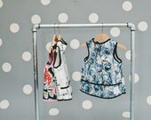 the smib  (a smock bib) in peacock, size toddler (9 to 24 months)