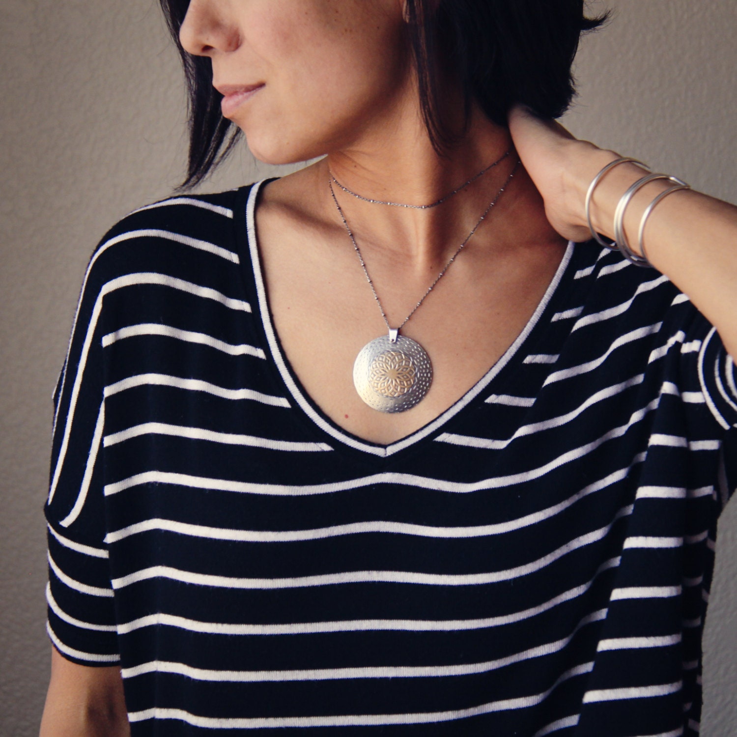 Large round sterling silver and brass necklace with an intricate pattern hanging from a long opera length silver chain - "Mandala Necklace"