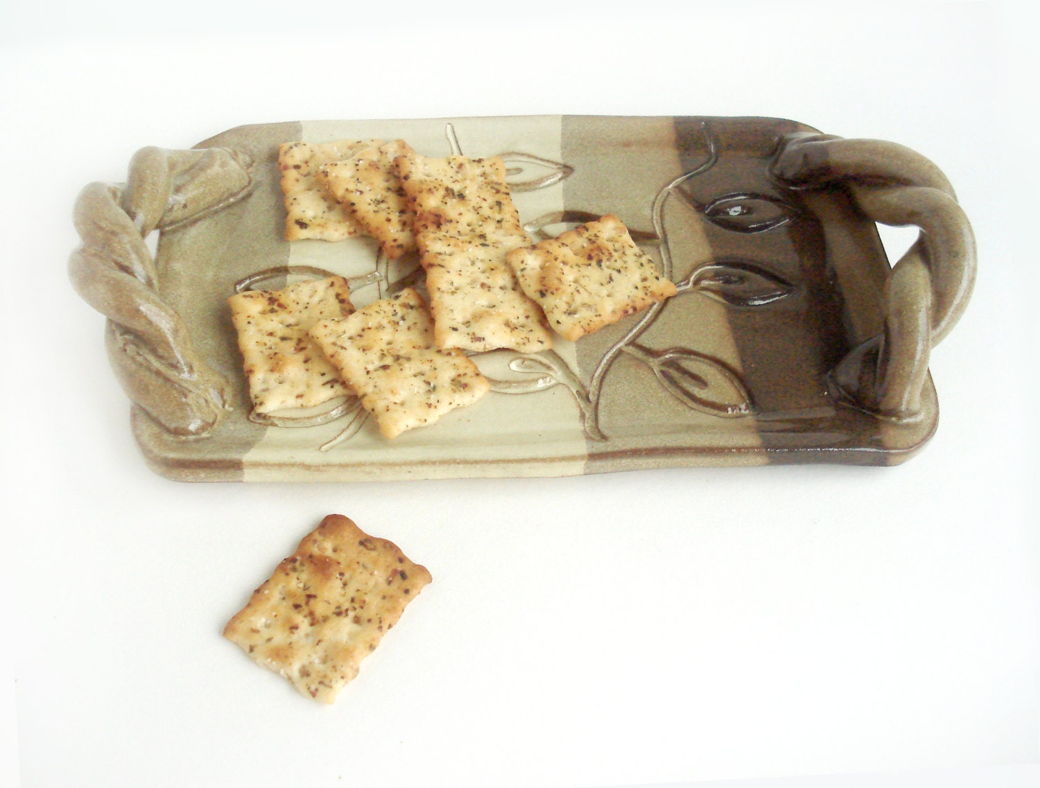 Small handmade pottery tray with leaves and twisted handles: stoneware