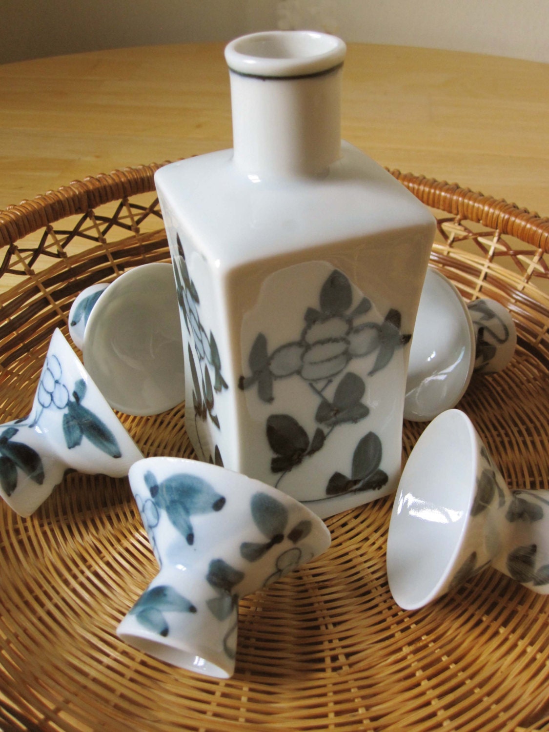 Saki or Sake - Its All Fun - This Lovely Set is Porcelain With Six Cups in Deep Greyblue - The Bottle is Square With Japanese on the Bottom