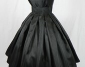 A Gorgeous Black Shantung 50s cocktail dress, fully lined and shown wearing a petticoat