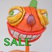 Halloween Pumpkin Man in White Black Orange Purple and Green with a Candy Corn Bucket