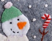 Snowman holding a candy cane, wool felt Christmas ornament, hand embroidery, green hat