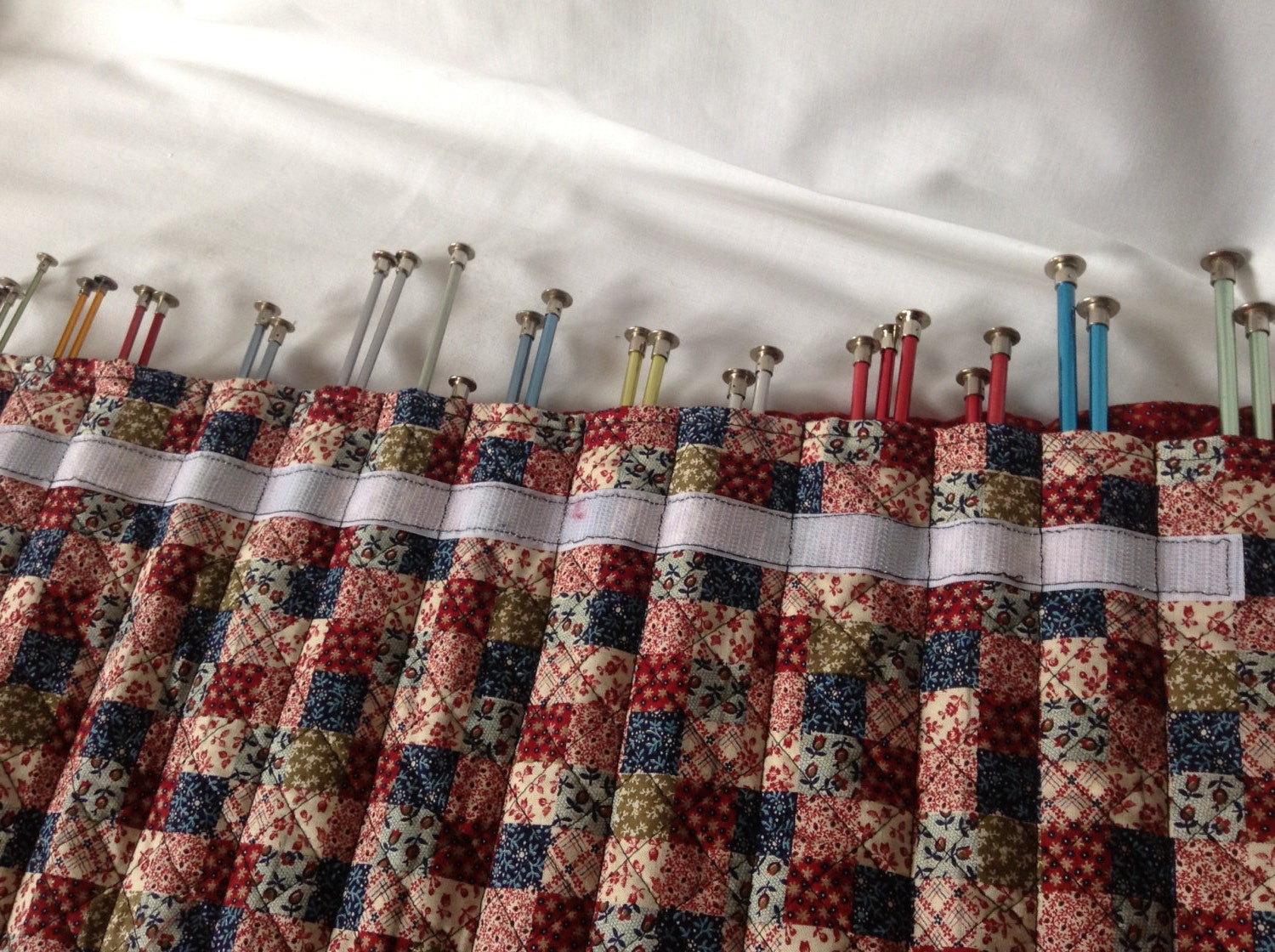 Knitting needles in handmade quilted roll up carrying case