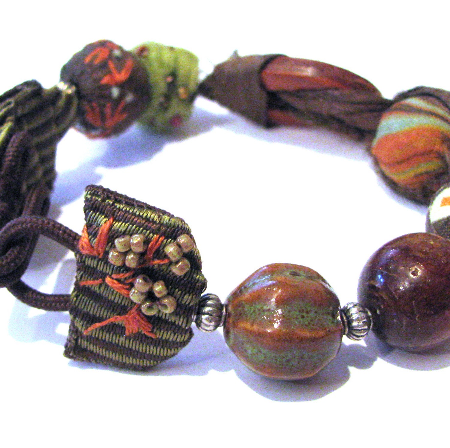 OOAK Hand Embroidered Raw Silk  Bracelet. Embroidered Embellished closure and felt bead. Fabric,Leather,Golden Coral,Felt and Ceramic.
