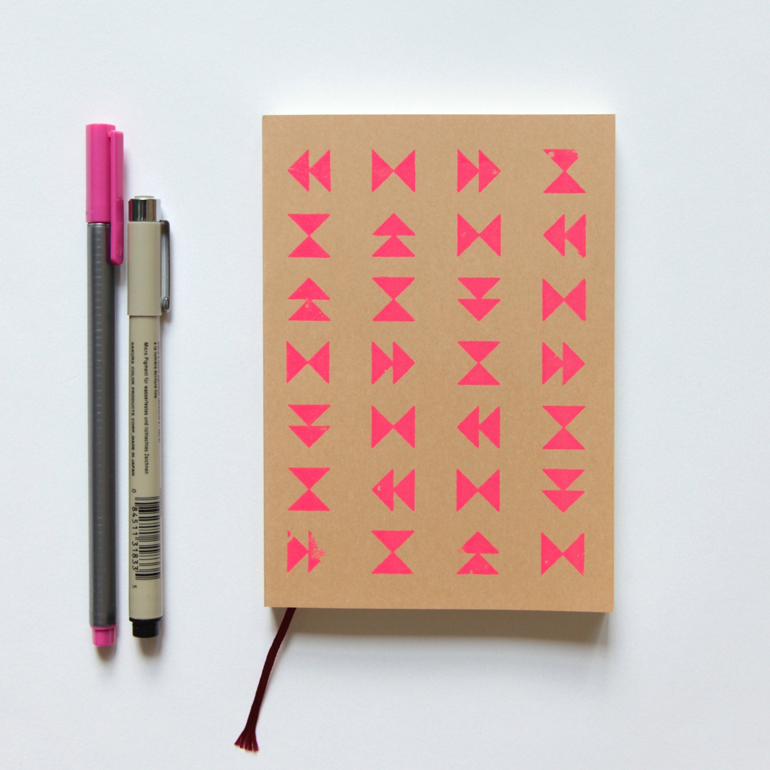 neon pink screenprinted sketchbook or notebook journal, geometric triangle design