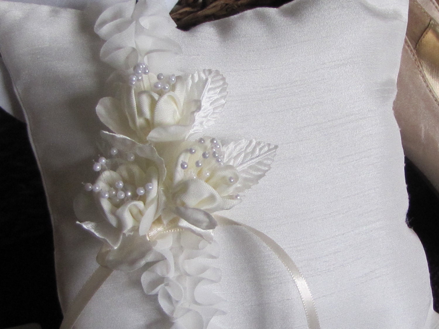 Aubray, a ring pillow in shades of ivory with ruffles ,flowers and pearls