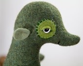 Olive the olive green mystery skunky skoggy animule in recycled speckled green lambswool