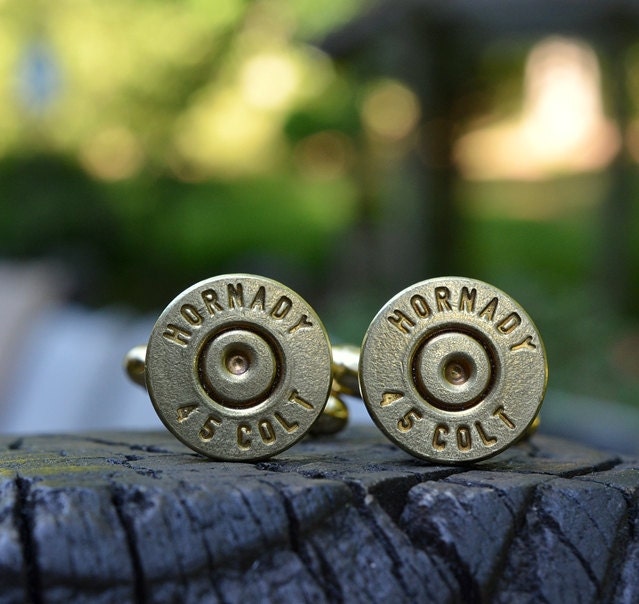 Bullet cufflinks fashioned from repurposed gold/brass Hornady .45 Long Colt shell casings
