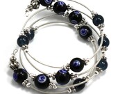 Steel Coil Wrap Bracelet with Black Glass Evil Eye Beads and Pewter Beads - anjalicreations