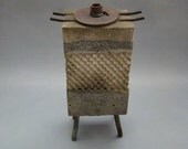 TEA HOUSE MOON - A Cast Stone Textured Vase of Small Proportions with Iron and Steel