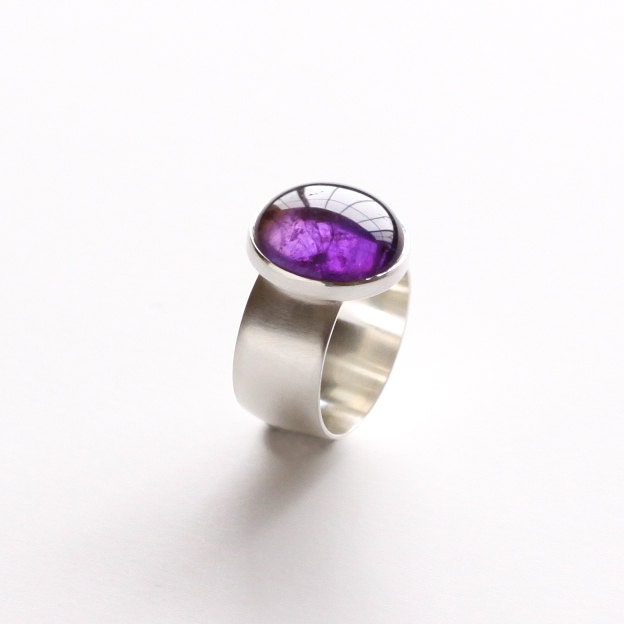 Modern silver ring with purple amethyst in a sleek and stylish setting on a wide comfortable band - "Amethyst Burst Ring"