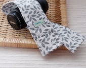DSLR Camera Strap Cover, Padding and Lens Cap Pocket, Canon and Nikon Compatible - Leaves in Grey
