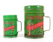 Two Elton Kirby's Tin Pepper Shakers