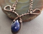 Victorian inspired arch and drop design copper necklace with cobalt blue lapis lazuli stone on chain.