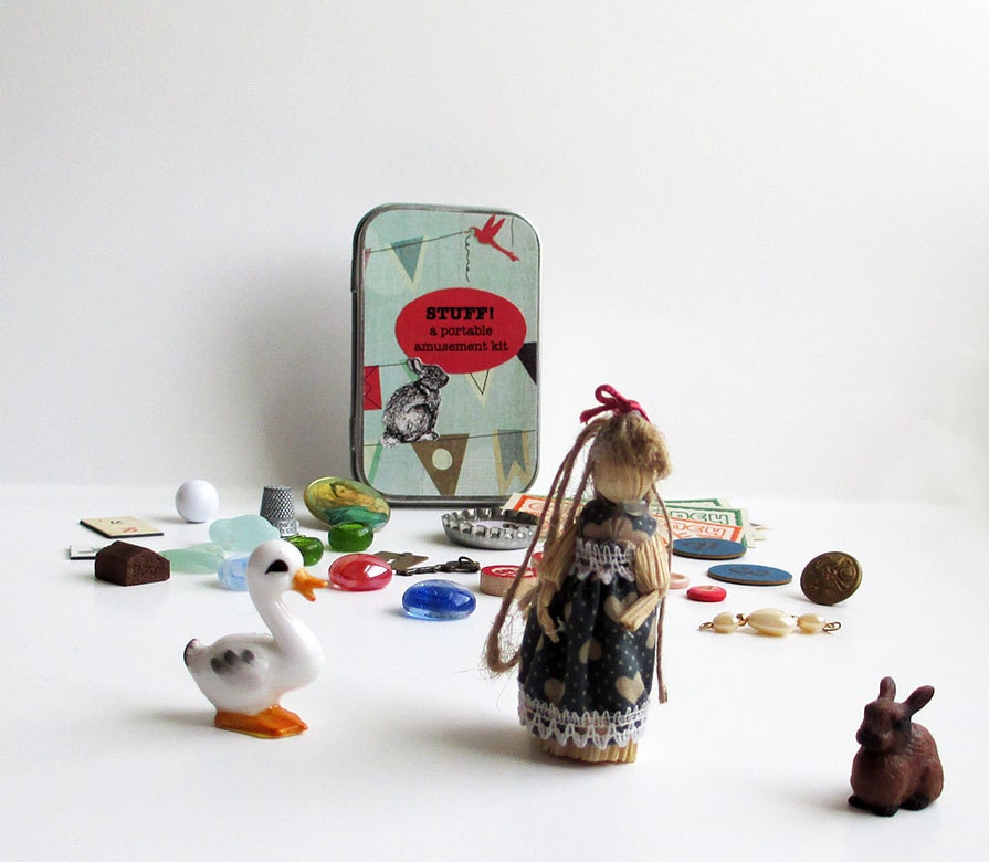 Toy set with little vintage doll, duck, bunny, other small vintage toys and game pieces for creative play and storytelling in a little box