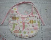 Pink rosebuds, caterpillars, turtles, butterflies, and bumble bees are adorable on these baby/infant bibs