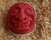 Red Hand Carved Caricature Golf Ball with a Grin