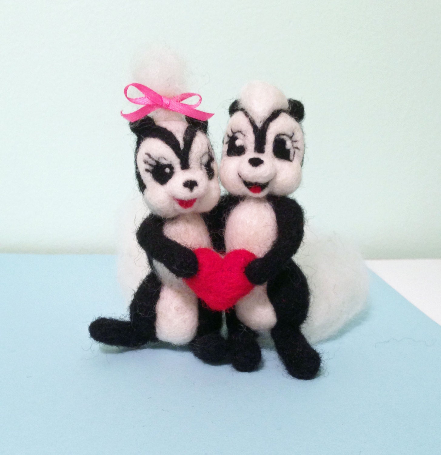 Felted Skunk Couple Holding Heart