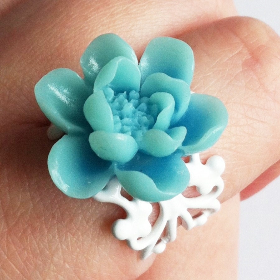 Something Blue Bridal Ring with pale blue lotus flower on a white filigree band in ivory organza gift bag for bride on wedding day