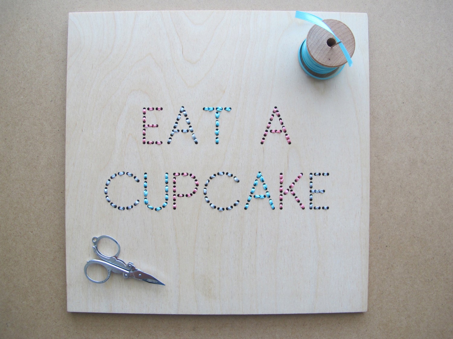 eat a cupcake - laser cut and embroidered wall art