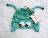 caterpillar hat in light blue, turquoise and green with earflaps
