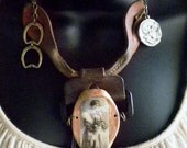 SOLD to a very stylish woman.upcycled leather suspenders with assorted metal charms and chain with vintage image