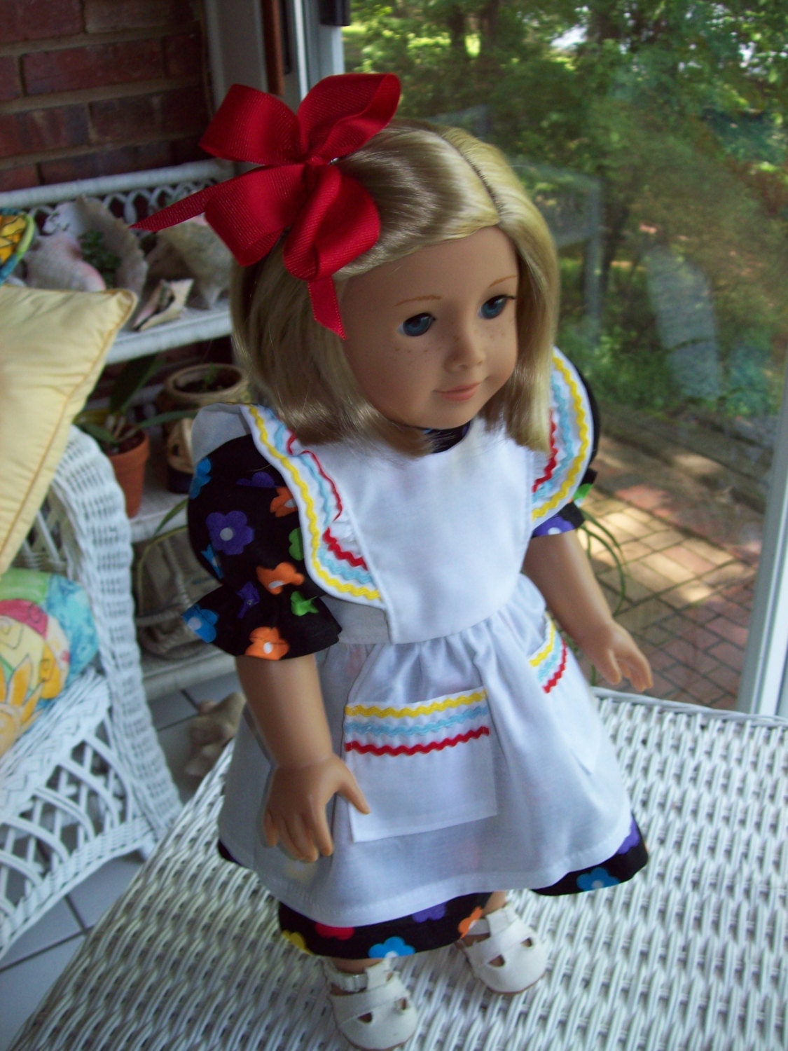 Dress and pinafore fits 18 inch doll or American Girl doll. Black floral cotton with white pinafore.