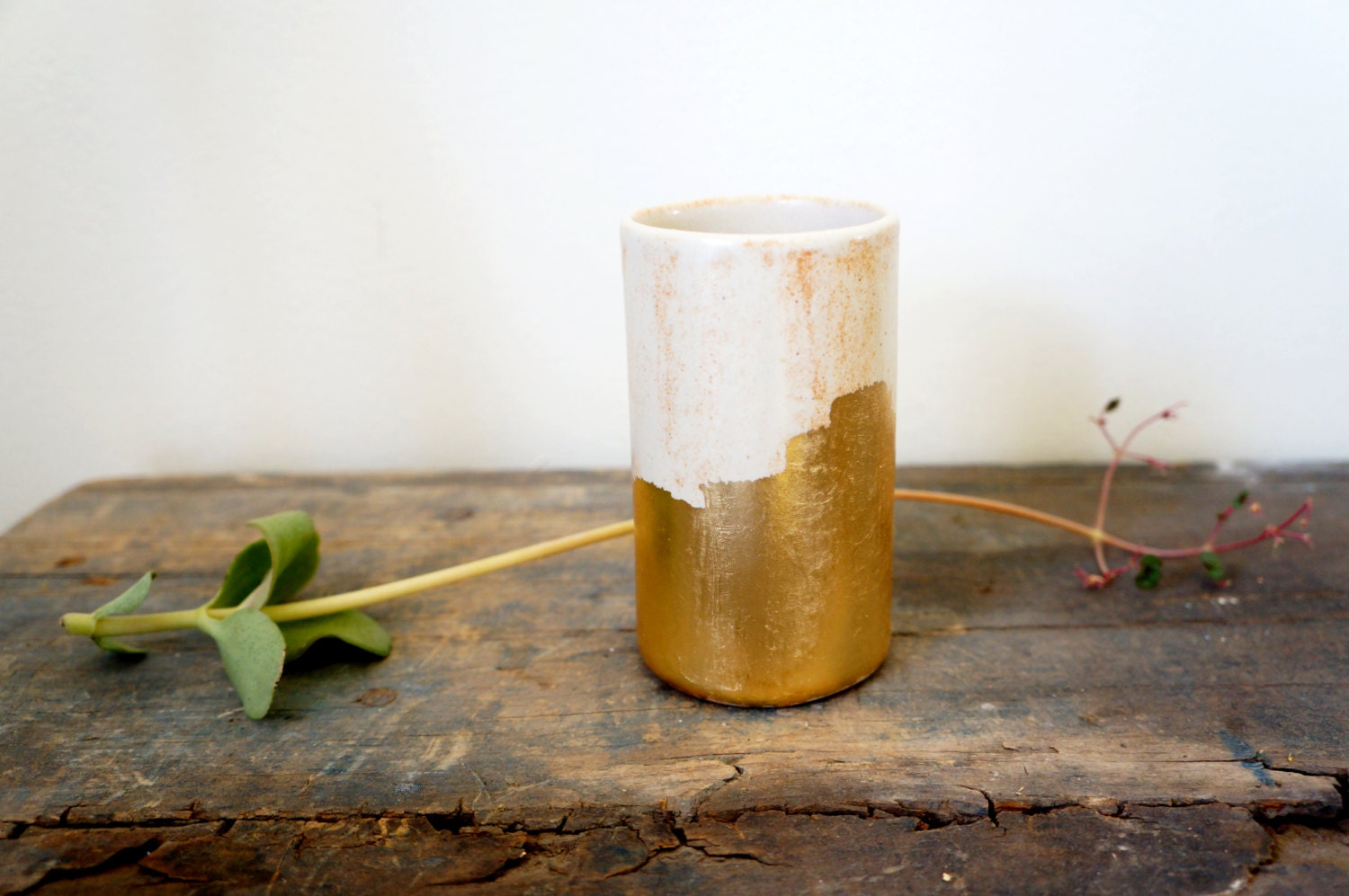 cream cylinder vessel with gold brush strokes