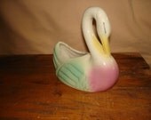 Vintage glazed ceramic swan with mint green and pink highlights