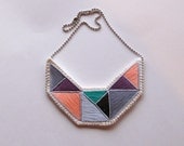 Small embroidered geometric bib necklace in emerald grays violet and peach triangles dramatic design