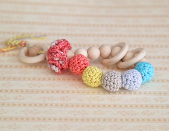 Teething toy rattle with crochet wooden beads and 3 wooden rings. Yellow, coral,baby blue, aqua blue/ cyan, beige.