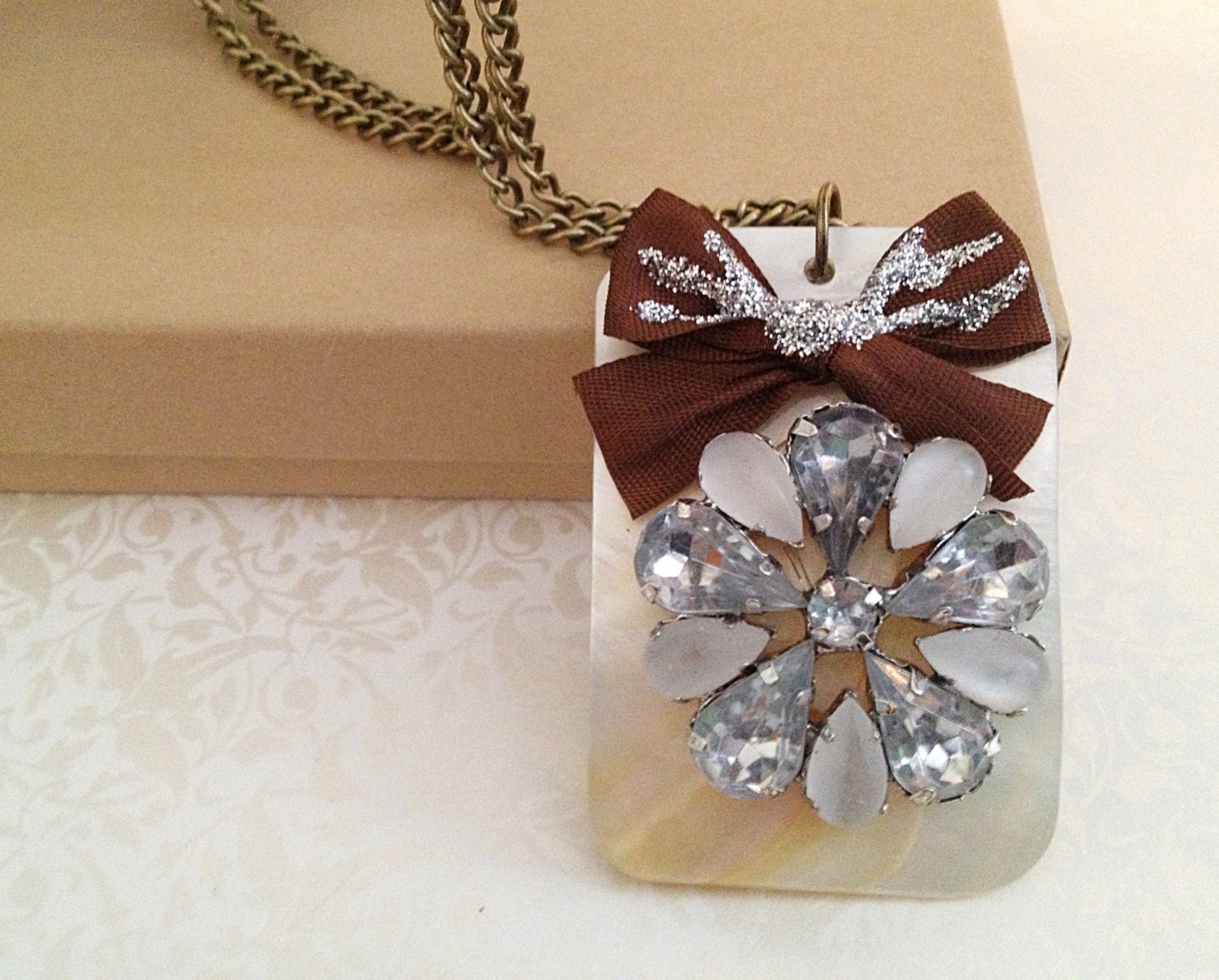 Vintage Style Rectangle Pendant Necklace. Ivory Shell. Brown Bow. Silver Glitter. Rhinestone Flower. Long Necklace. Brass Finish.