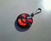 Scary goblin face zipper pull, fiery orange in gunmetal black