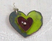 Copper heart pendant, enameled, apple green with dark red accent, orange back