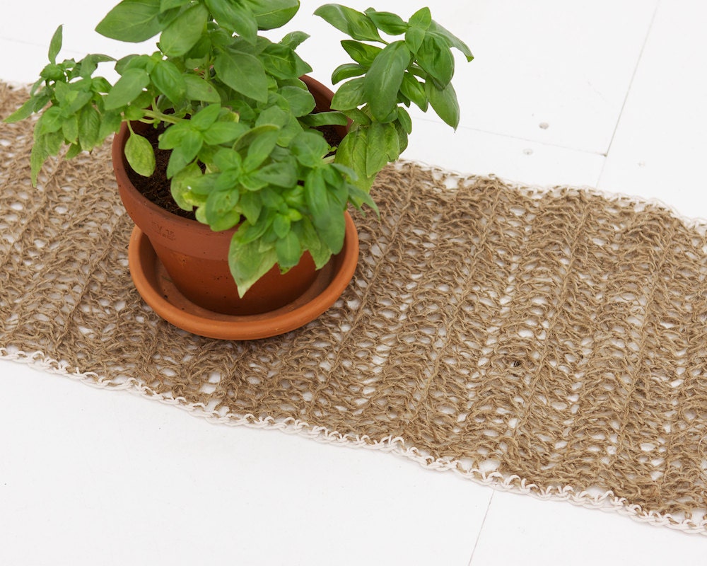 Crocheted twine table runner in natural jute twine with white cotton edging
