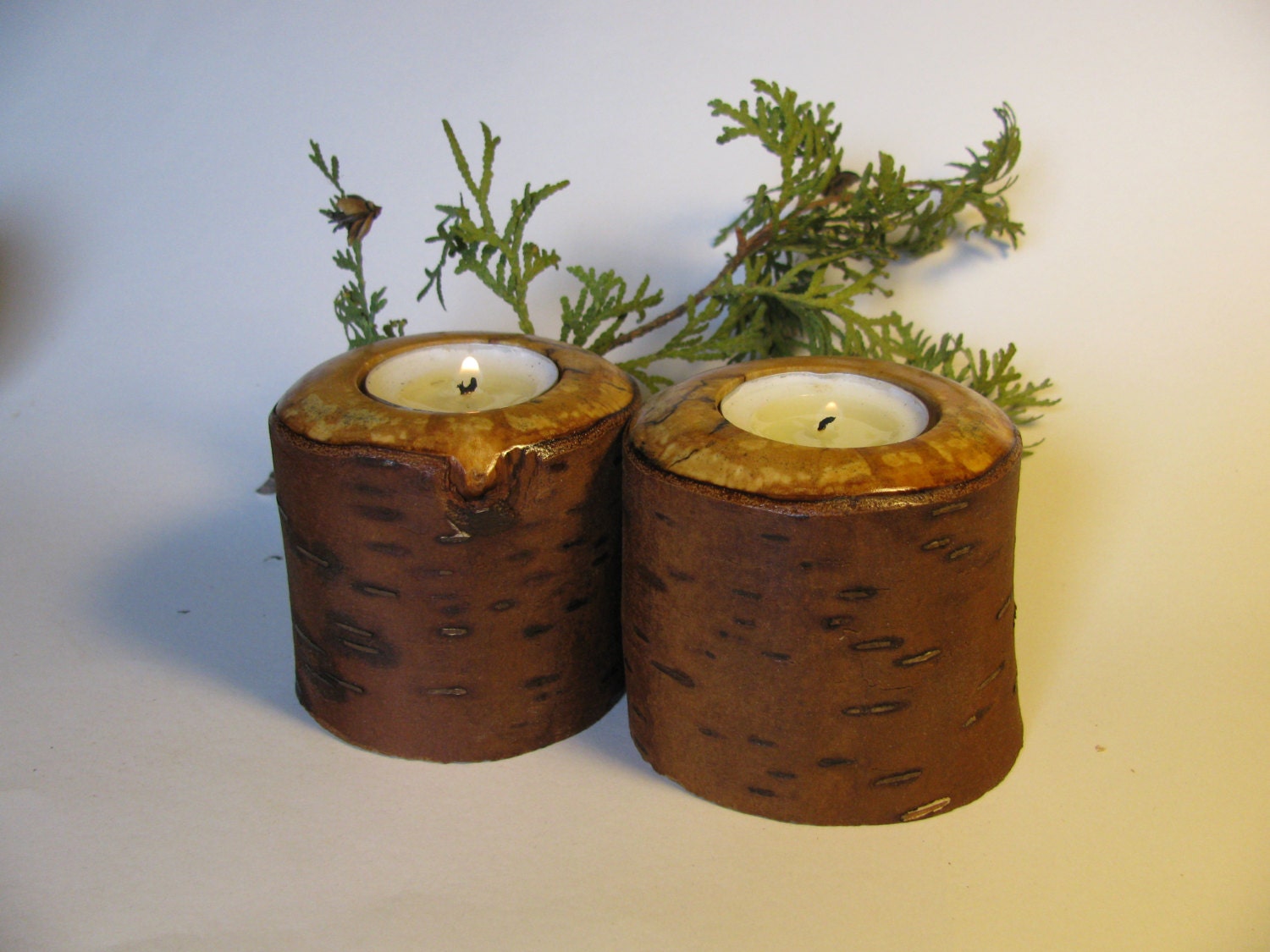 Two woodland tea light candle holders cut from red birch.