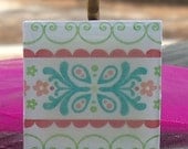 Patterned Necklace with Pretty Flowers Pastel Colors on Wood Tile