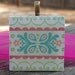 Patterned Necklace with Pretty Flowers Pastel Colors on Wood Tile